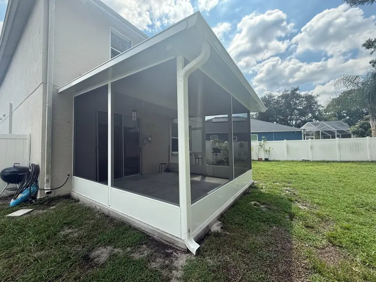 Crego crew installing a screened lanai enclosure at a Pasco County home