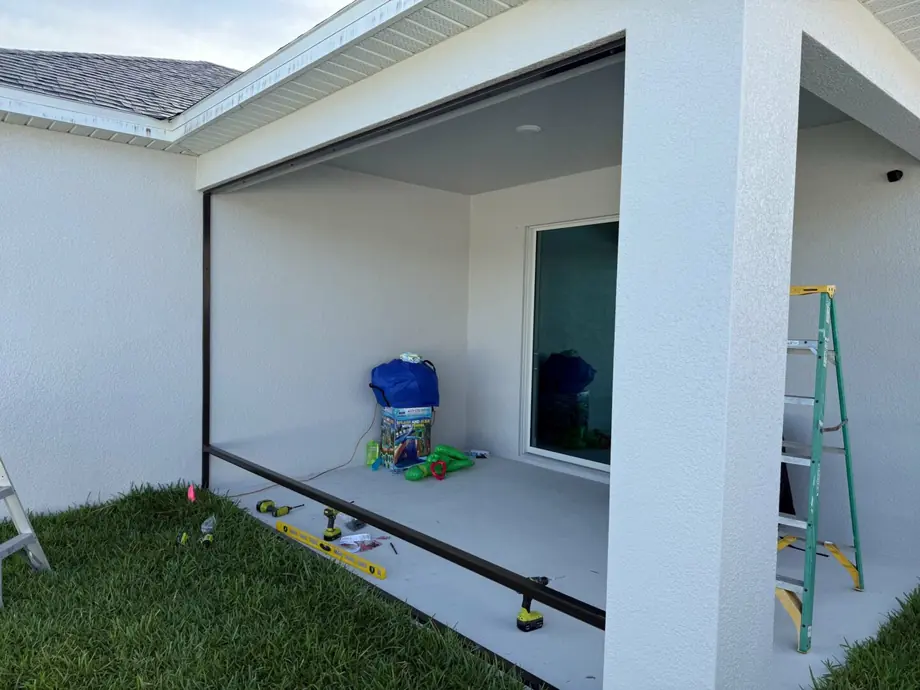 Infill screen enclosure fitted under an existing patio roof