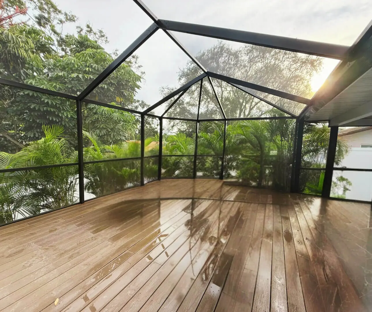 Screened pool enclosure at dusk with the lanai lit from inside