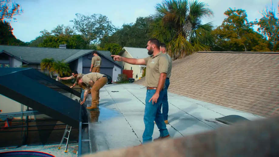 Technician repairing a torn screen panel on a Tampa Bay pool enclosure