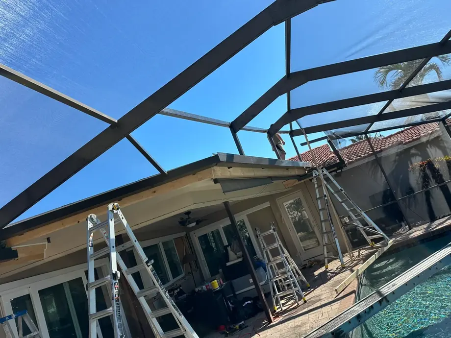 Screened lanai enclosure with a wood deck and open Florida views